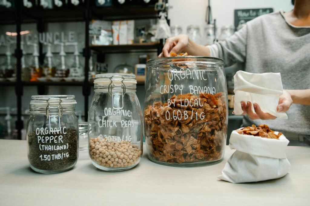 Person shopping at a zero waste store with organic products in reusable containers. Eco-friendly lifestyle.