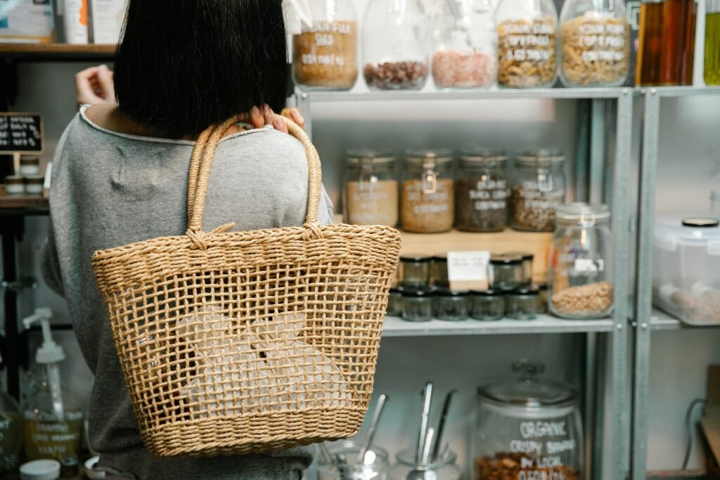 A woman with a wicker bag shops for organic products in a zero waste store.